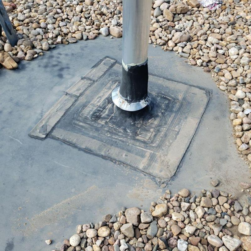 EPDM roof pipe flashing with sealant on ballasted roof
