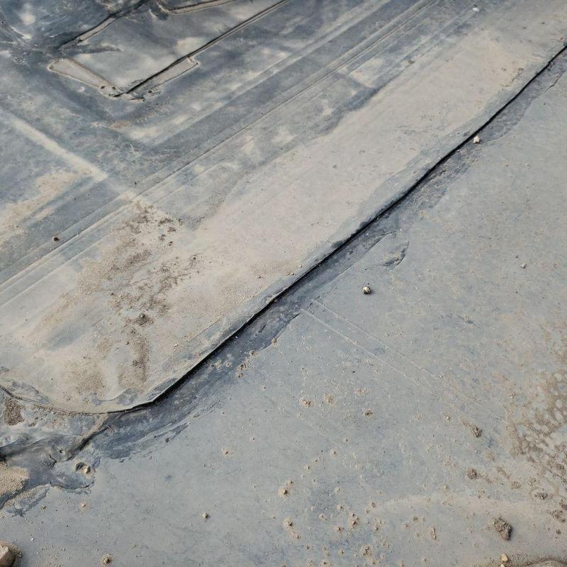 EPDM flat roof seam damage and wear detail