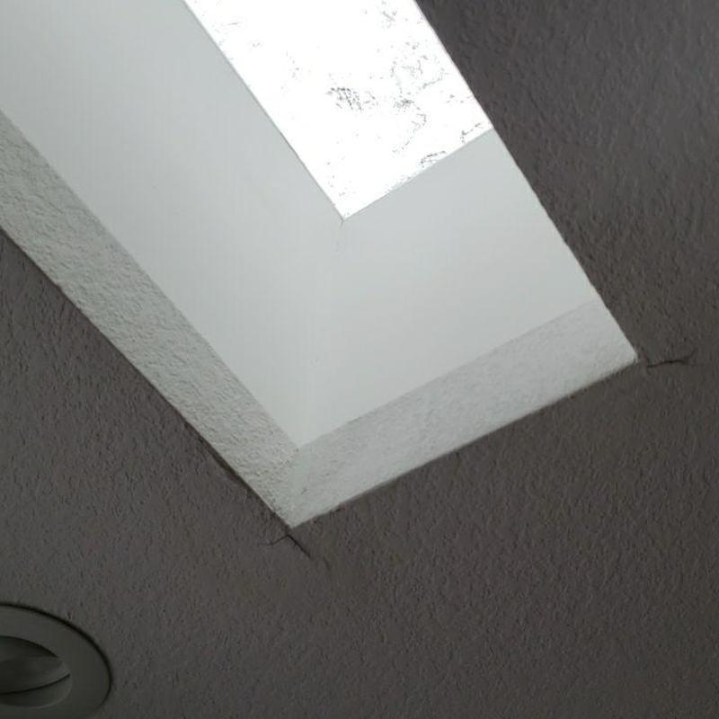 Skylight frame with ceiling cracks in corner