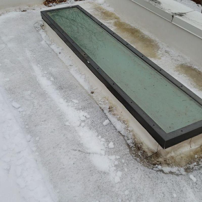 TPO flat roof with skylight and snow buildup