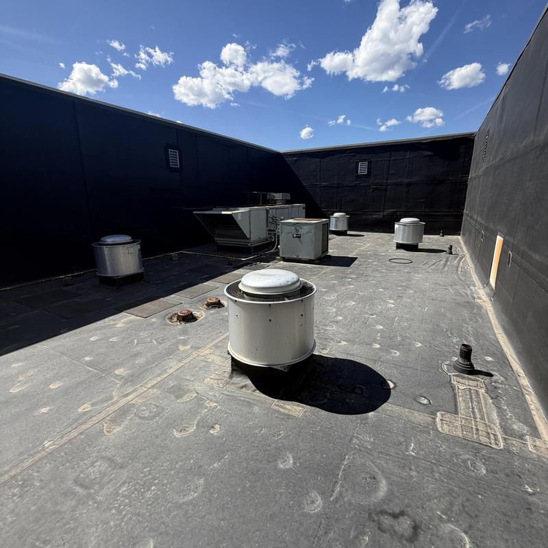 Roof exhaust fans on commercial flat roof