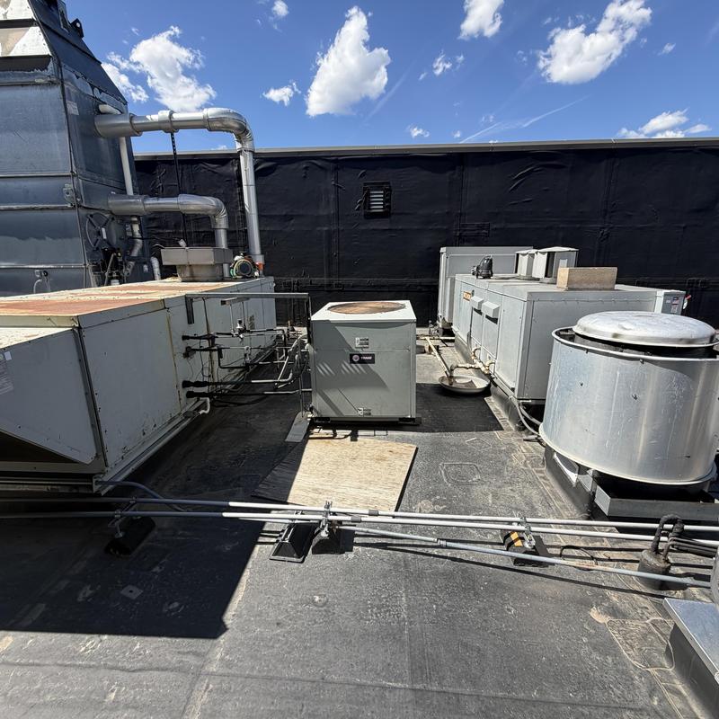 Trane rooftop HVAC units with ductwork and ventilation fans