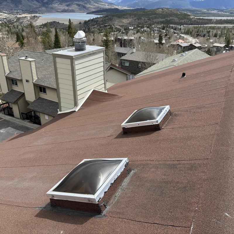 Skylight seals on shingle roof with caulking