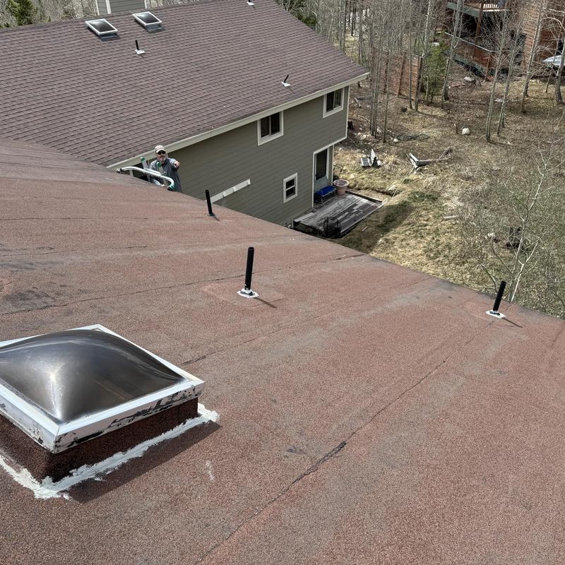 Skylight and vent sealing on shingle roof