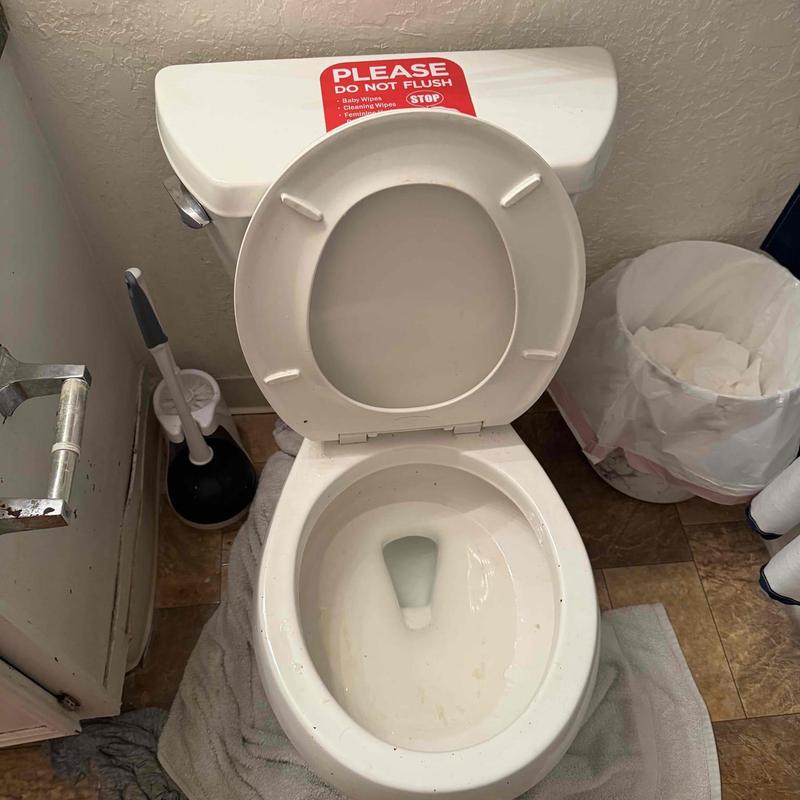 Toilet bowl with open lid and flush warning sign Toilet bowl with open lid and flush warning sign
