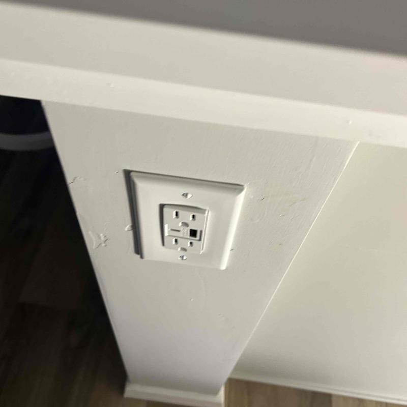 GFCI electrical outlet installed on wall corner