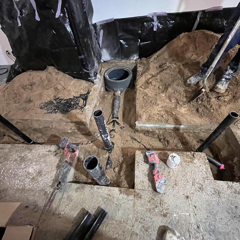 Sewage ejection pump pipe installation in basement cutout Sewage ejection pump pipe installation in basement cutout