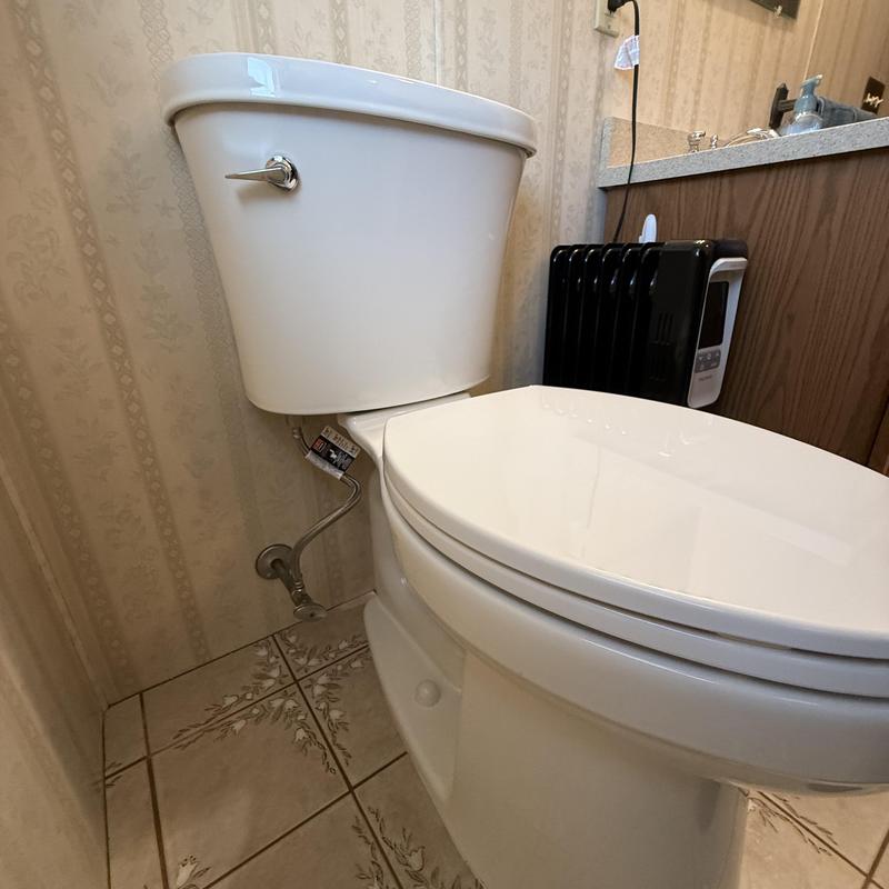 Toilet installation in residential bathroom corner