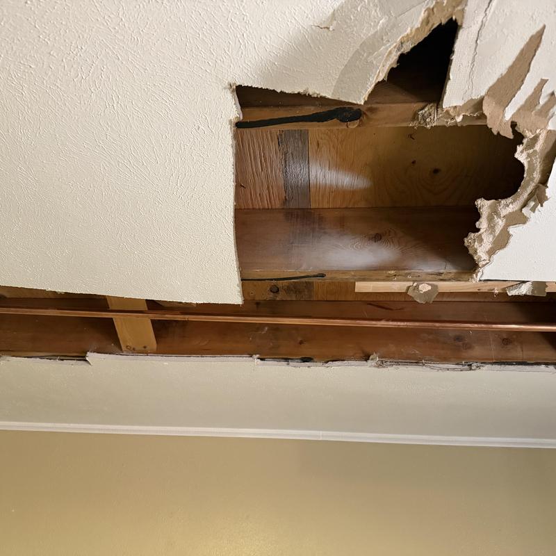 Copper pipe with pinhole leaks behind ceiling drywall
