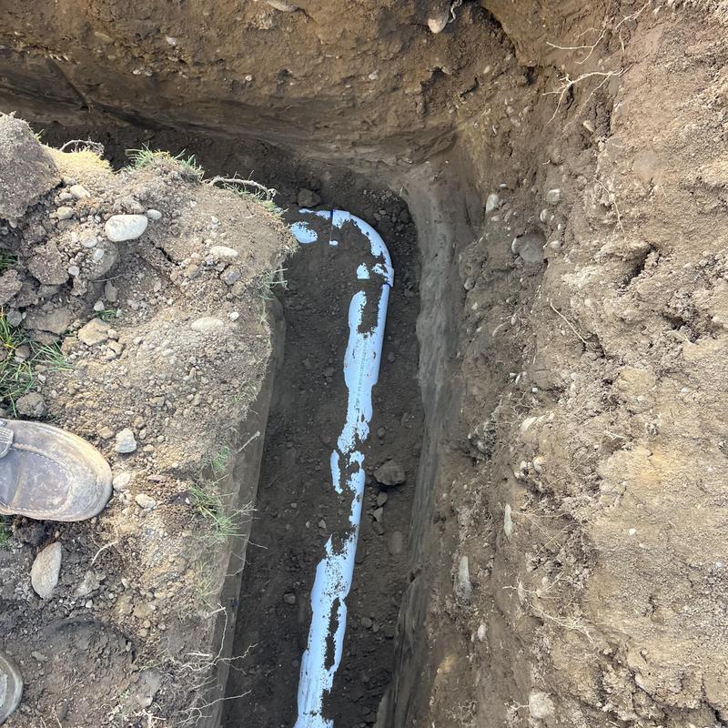 Sewerline installation in trench with elbow pipe bend Sewerline installation in trench with elbow pipe bend