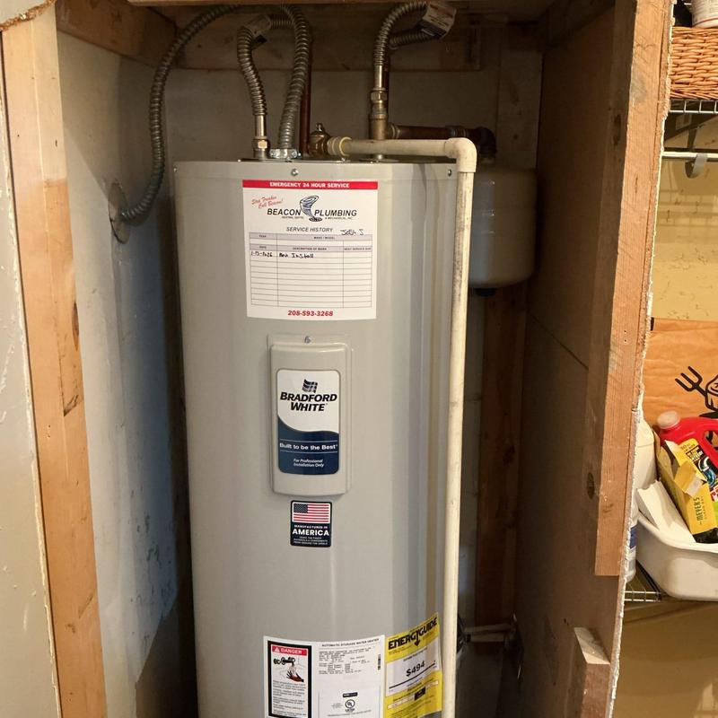 Electric water heater with plumbing connections in closet Electric water heater with plumbing connections in closet