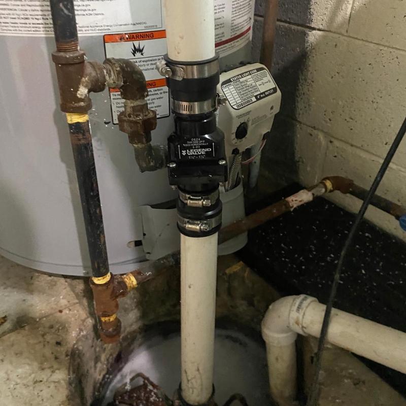 Sump pump check valve installation in basement pit