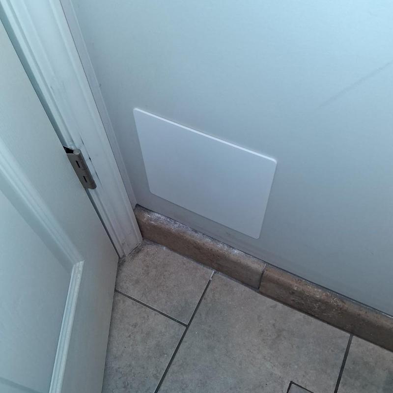 Drywall access panel installation near door jamb and tile floor