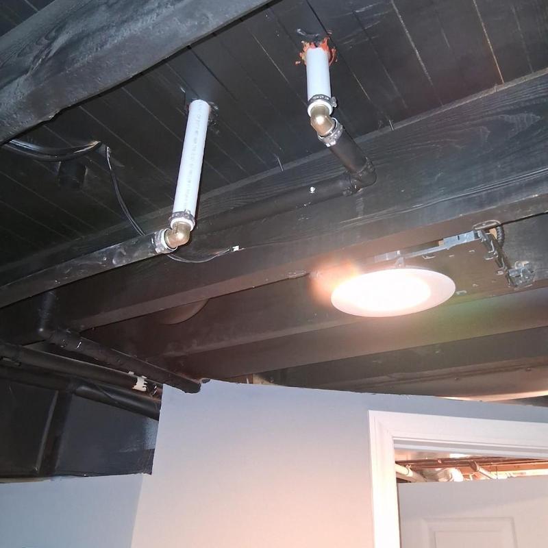 PVC pipe installation under ceiling in basement
