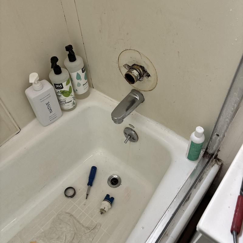 Shower faucet cartridge replacement in bathtub setup