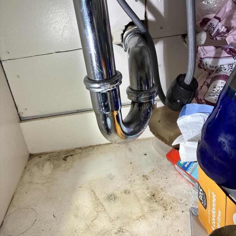 Chrome P-trap under kitchen sink with leak repair