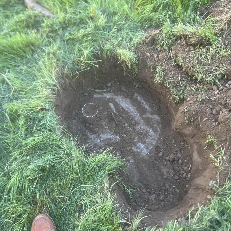 Septic tank inlet excavation and lid exposure in lawn Septic tank inlet excavation and lid exposure in lawn