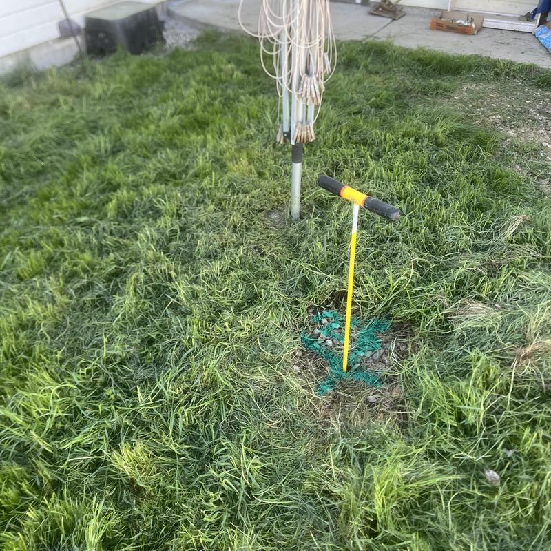 Septic tank inlet excavation marked in grassy yard Septic tank inlet excavation marked in grassy yard