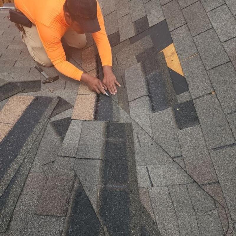 Storm damaged shingles being replaced on roof