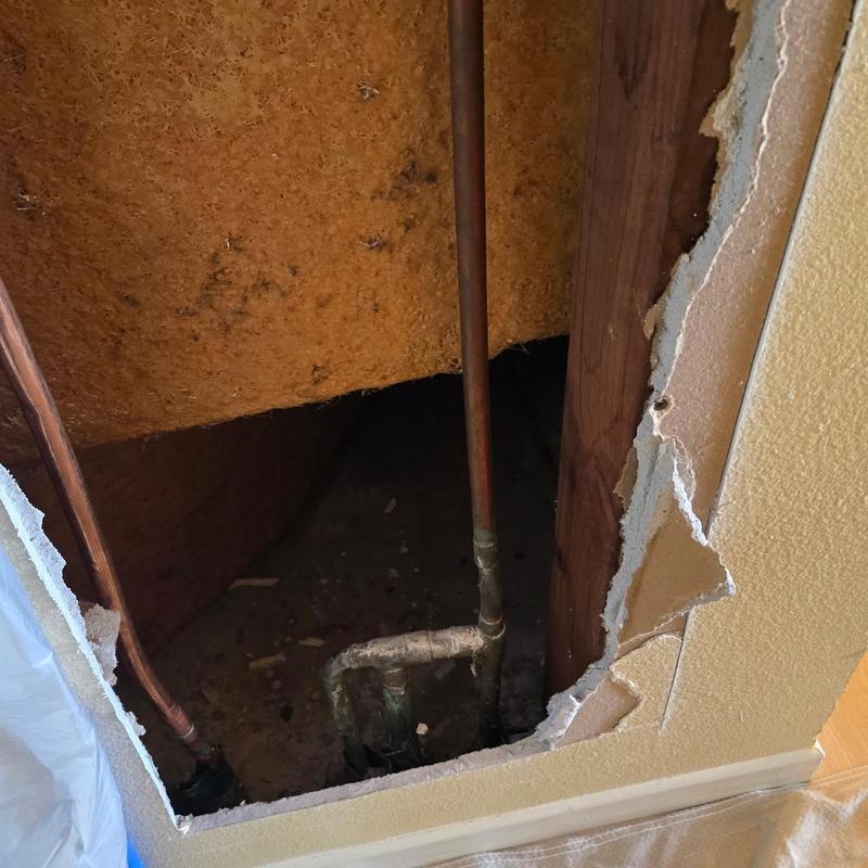 Copper water piping inside wall with hole cutout