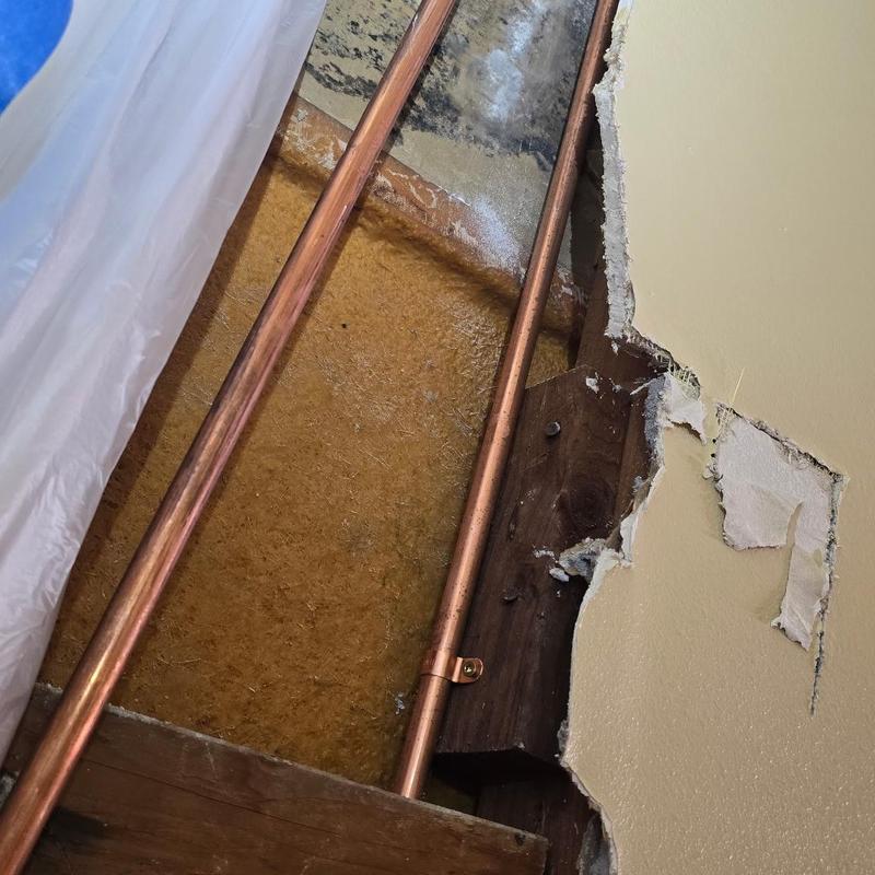 Copper water pipes with wall removed for leak repair