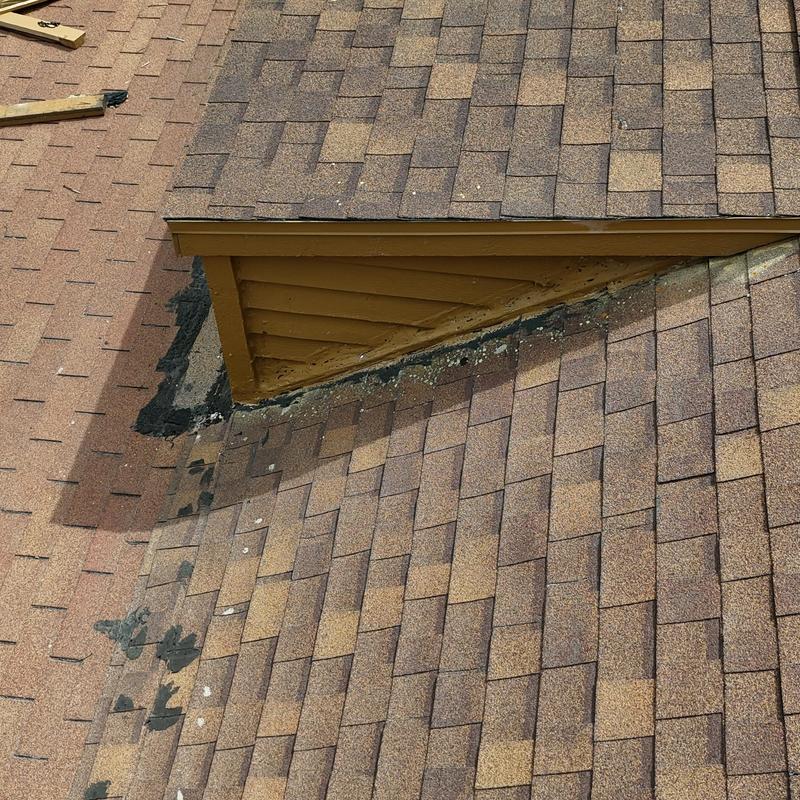 Asphalt shingle roof with dormer flashing and sealant