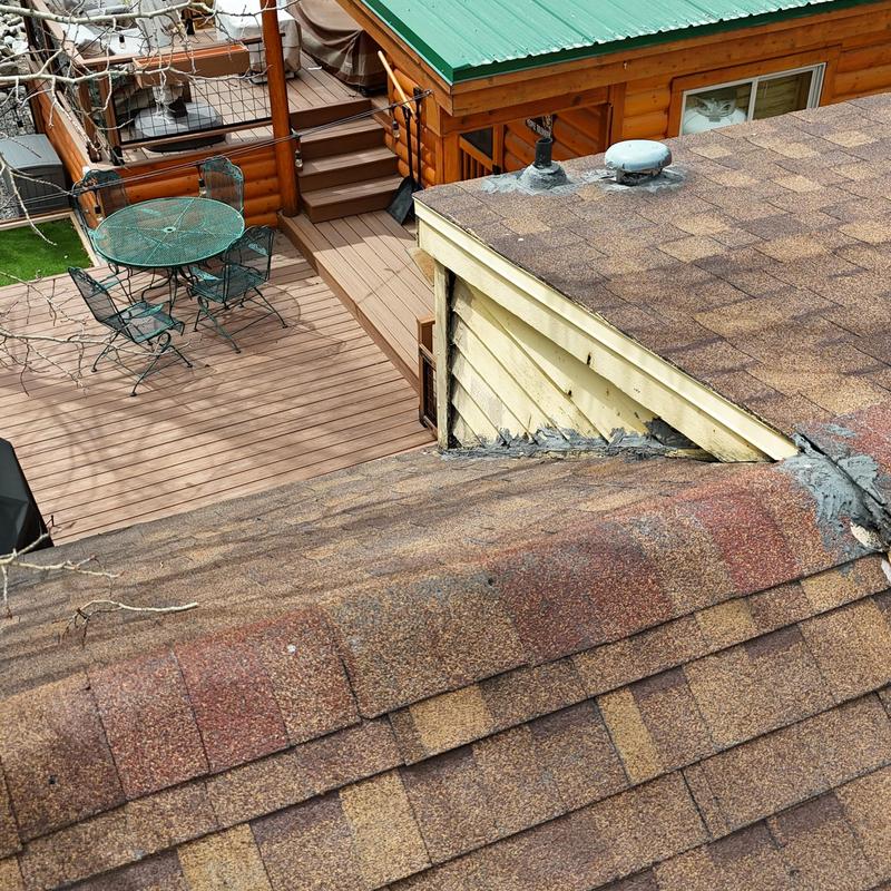 Asphalt shingle roof with visible wear and decking gap
