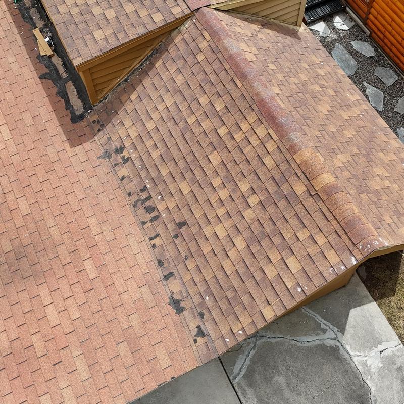 Asphalt shingle roof with wear and patching in Idaho Springs