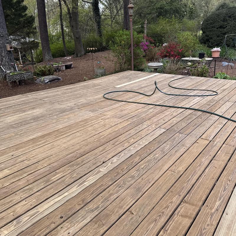 Wooden deck boards with garden hose laid out