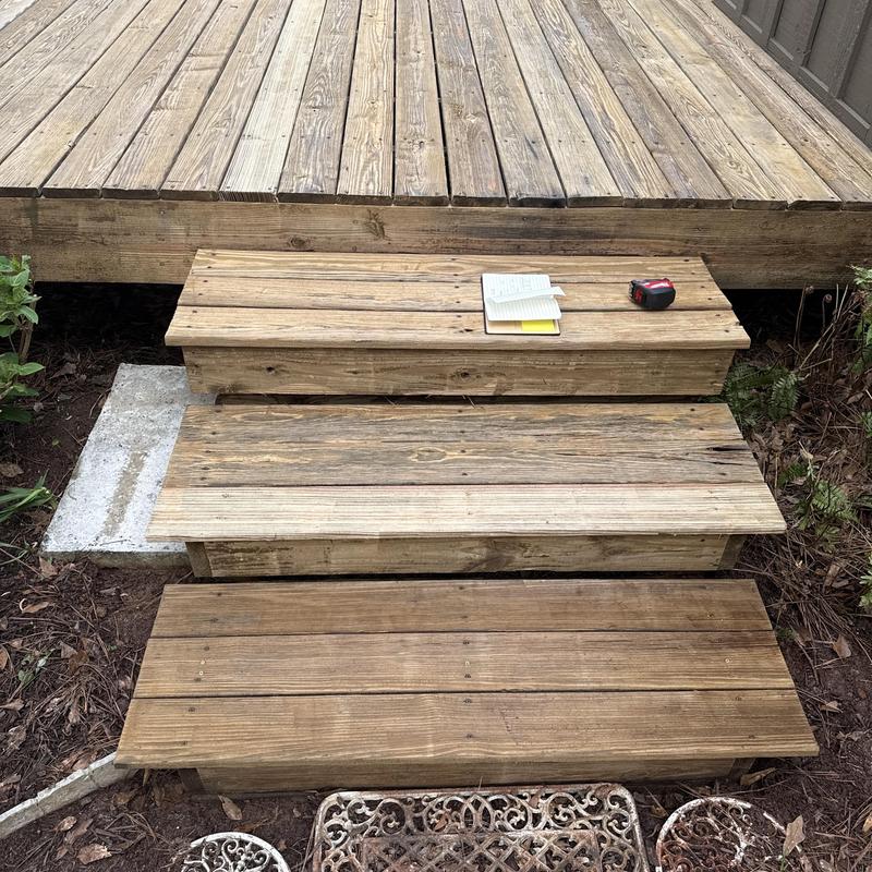 Wooden deck stairs with deck boards needing replacement