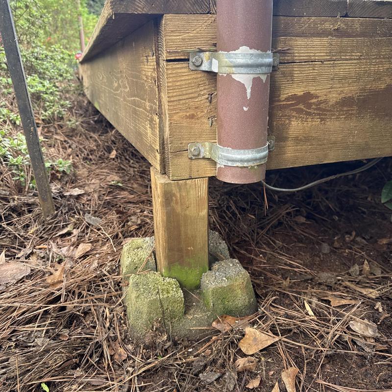 Floating deck support post on concrete blocks
