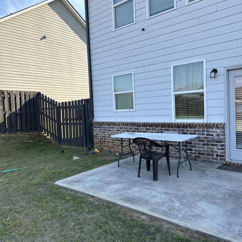 Concrete pad installation with plastic chair and table