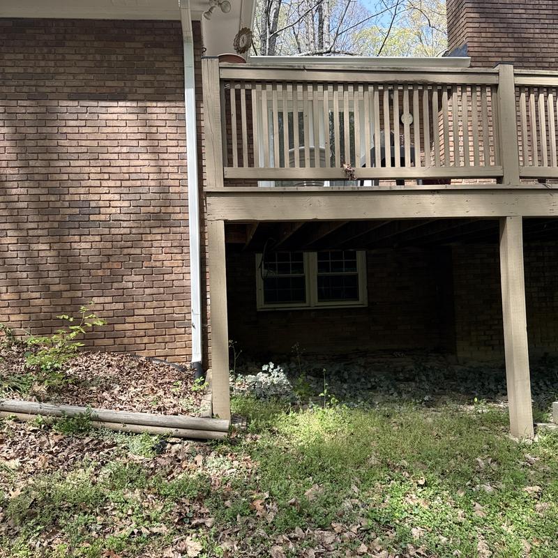 Wooden deck with railing and support posts