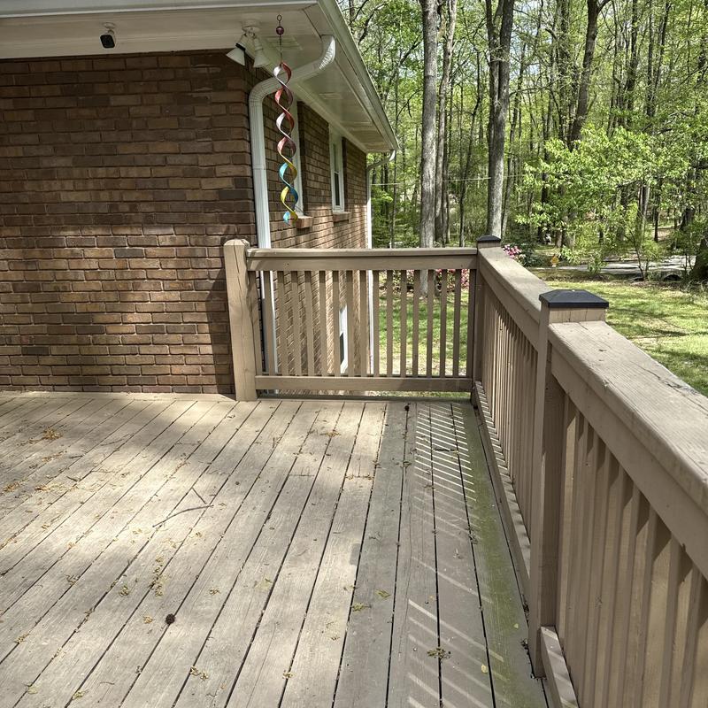 Wooden deck railing and flooring with weathering signs
