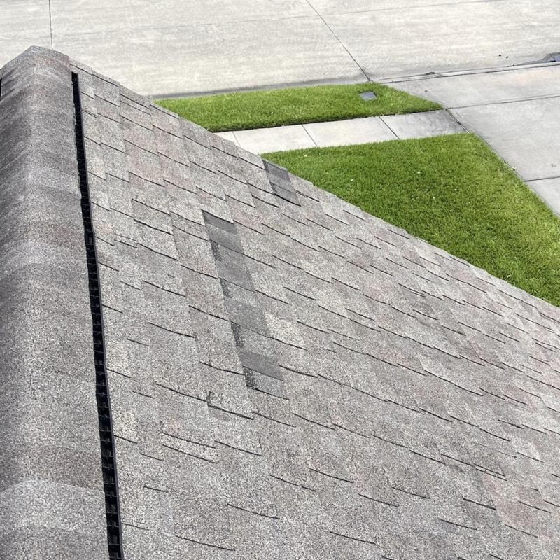 Asphalt shingles patch and replacement on residential roof Asphalt shingles patch and replacement on residential roof