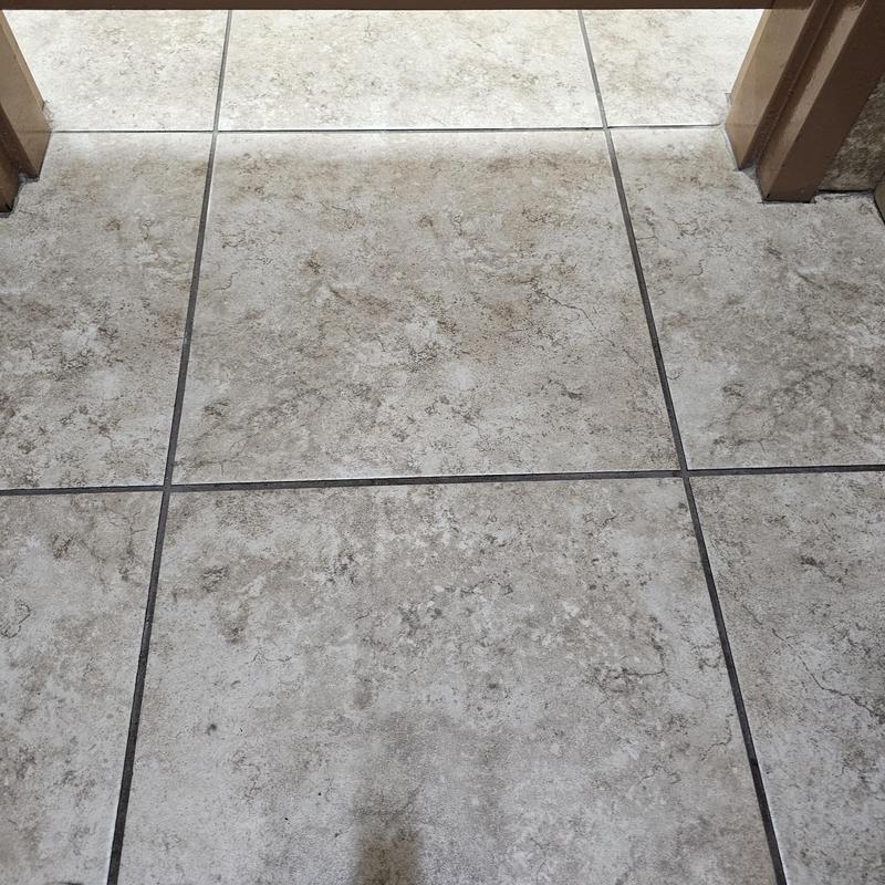 Ceramic floor tile with grout lines in hallway doorway