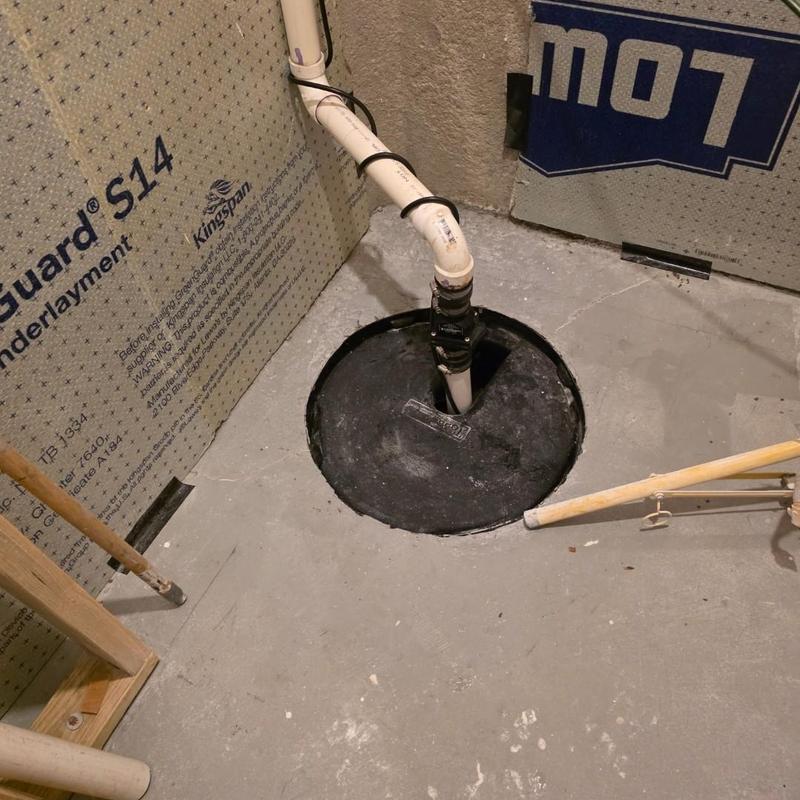 Sump pump with check valve installation in basement