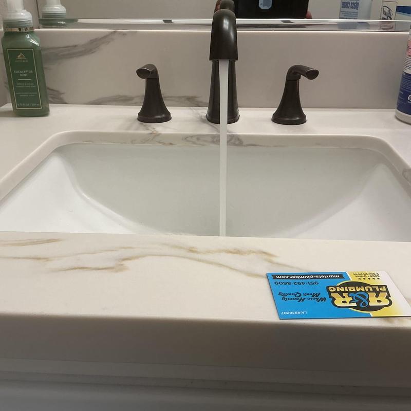 Wide spread bathroom faucet with water running