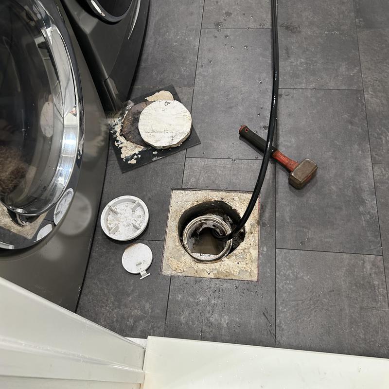 Laundry drain pipe jetting with plumbing snake and hammer Laundry drain pipe jetting with plumbing snake and hammer