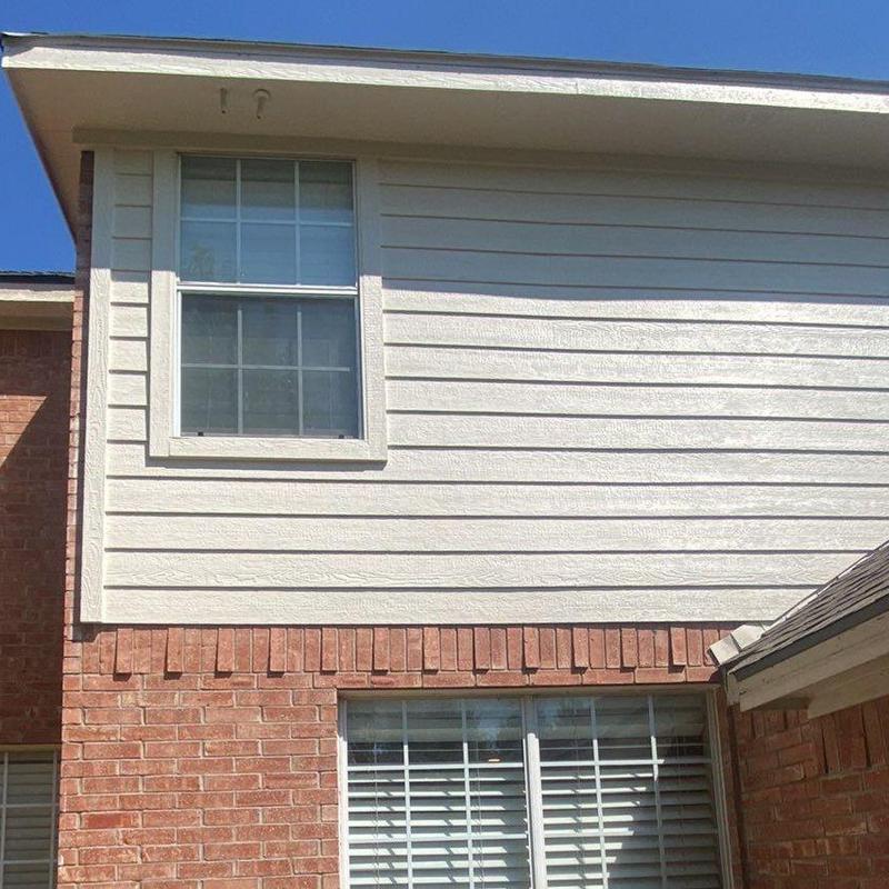 LP SmartSide siding and trim on brick home exterior