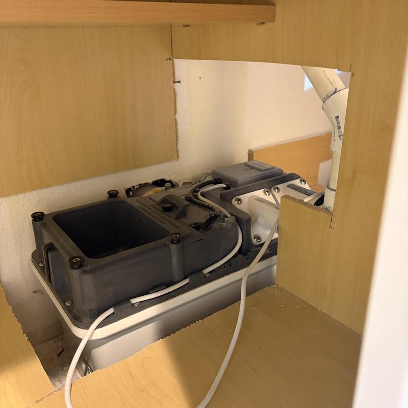 Ejector pump with cleared clog inside cabinet Ejector pump with cleared clog inside cabinet