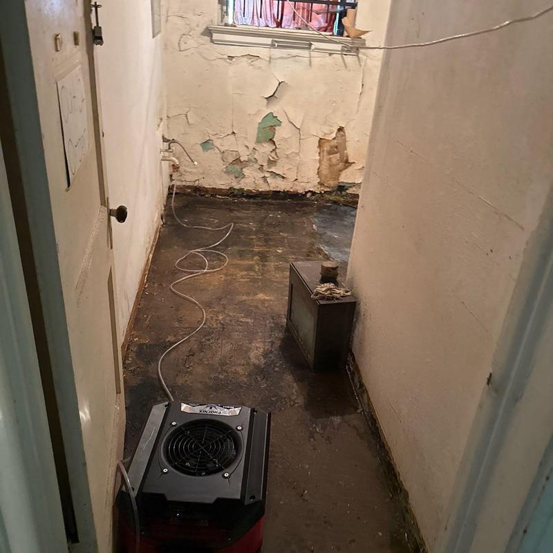 Basement floor water damage with drying equipment