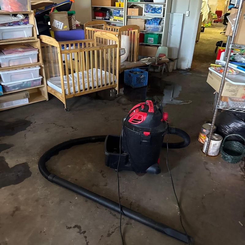 Wet dry vacuum cleaner on flooded basement floor