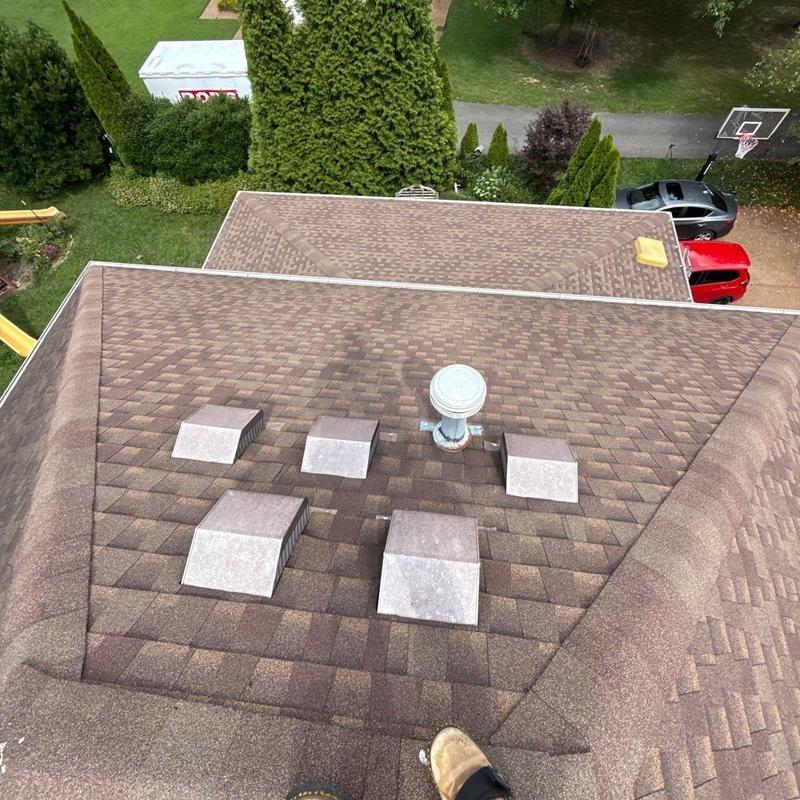 Asphalt shingles roof with vent caps and pipes