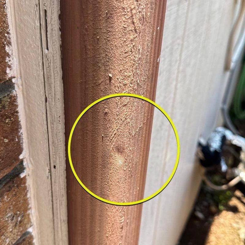 Downspout copper dent with surface texture damage