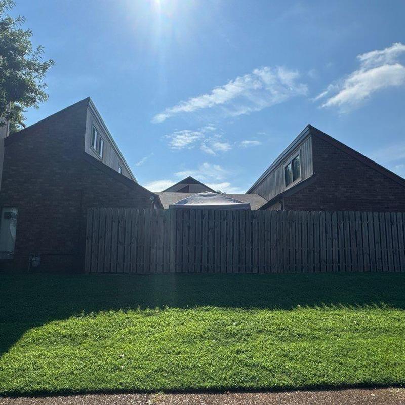 Multi-unit roof with hail damage and fence barrier