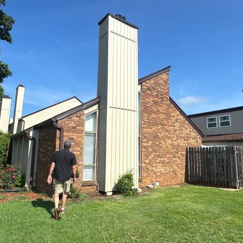 Chimney siding inspection on residential brick house