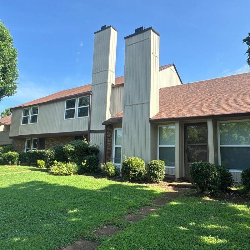 Residential roof with hail damage and chimney structures