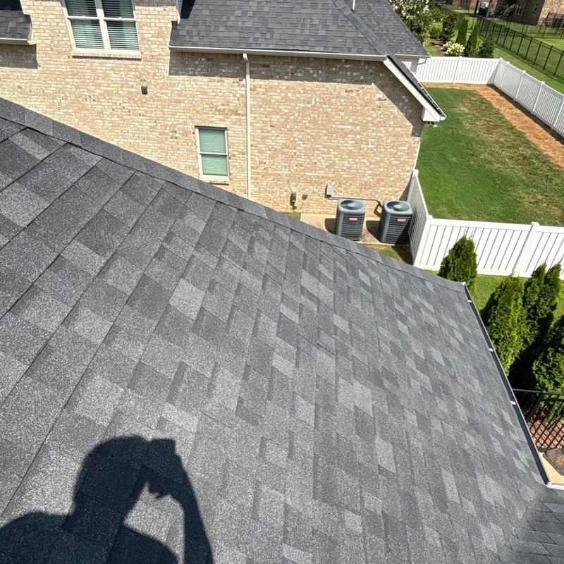 Asphalt shingle roof with visible granule wear and damage