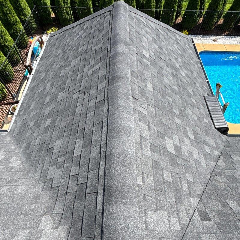 Asphalt shingle roof with ridge cap and vent near pool